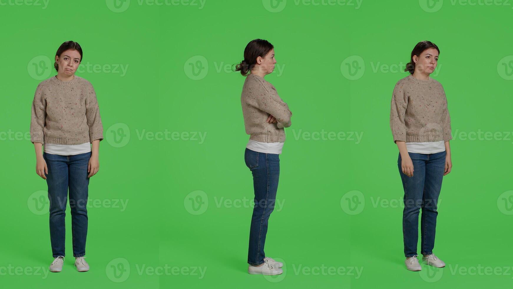 Discontent upset woman acting sad and discouraged posing over greenscreen backdrop, being disappointed and depressed. Young sad adult standing over full body studio background. photo