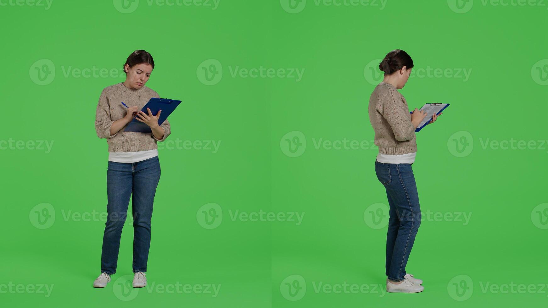 Confident woman looking at clipboard files on full body greenscreen, taking notes on papers and working on analysis. Female model writing information on documents in studio. photo