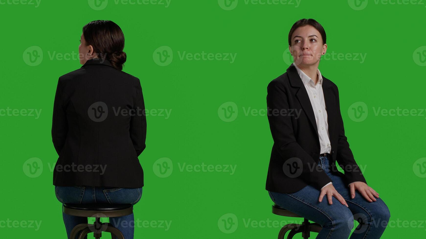 Close up of company worker waiting on chair before attending business meeting, sitting in studio with greenscreen background. Woman dressed in office suit working as employee or manager. photo