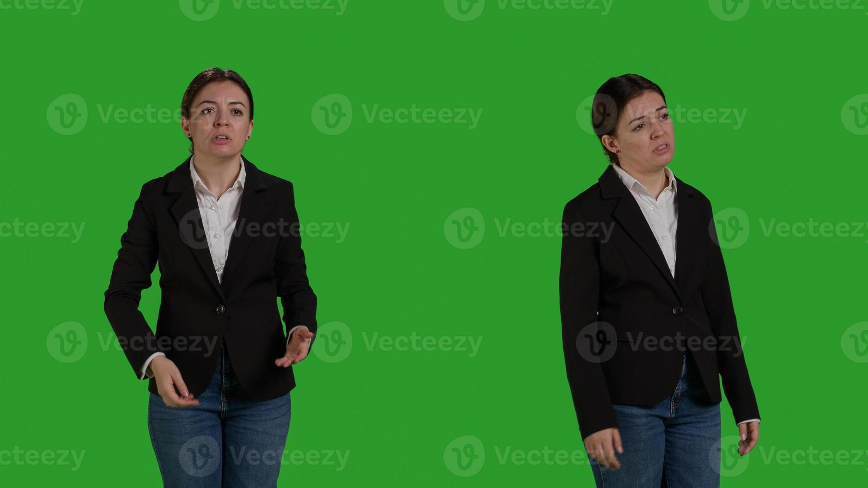 Young angry businesswoman acting negative and furious on camera, standing over greenscreen backdrop. Female employee being in conflict and expressing disagreement or disapproval in studio. photo