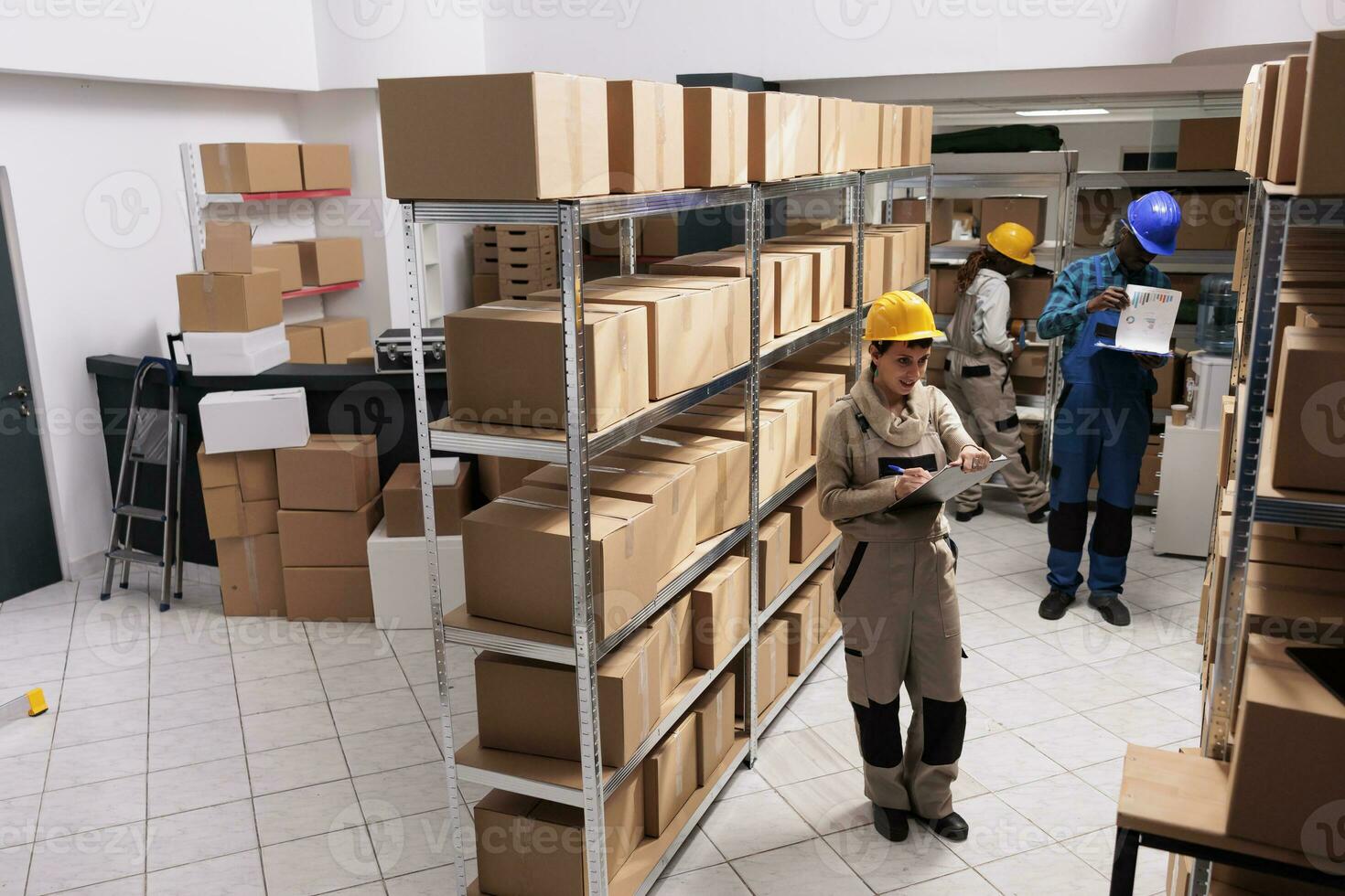 Factory warehouse managers diverse team making goods inventory, checking export report analytics. Storehouse man and woman supervisors working in stockroom and managing dispatching photo