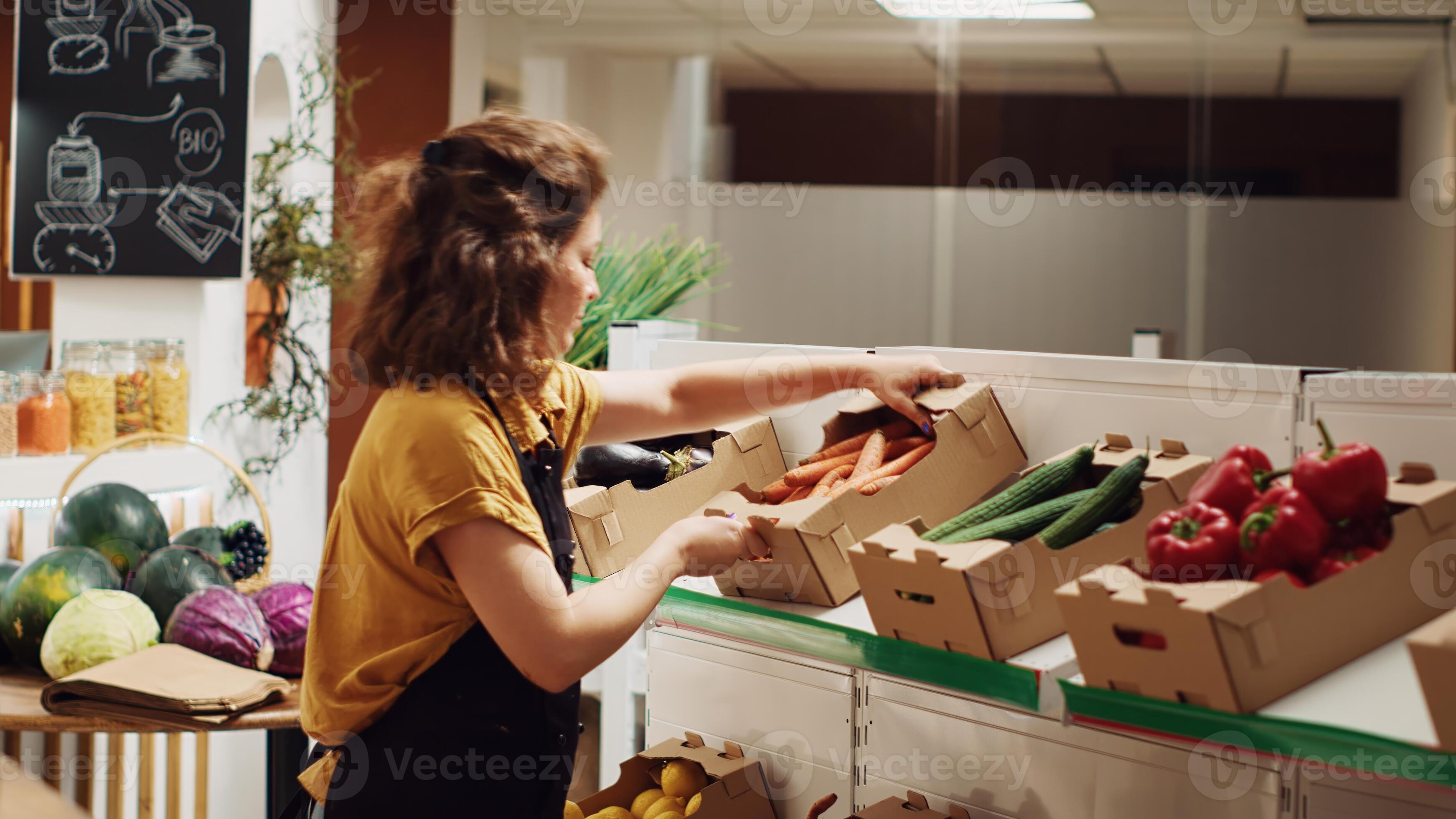 Busy vendor in zero waste supermarket refilling shelves with fresh