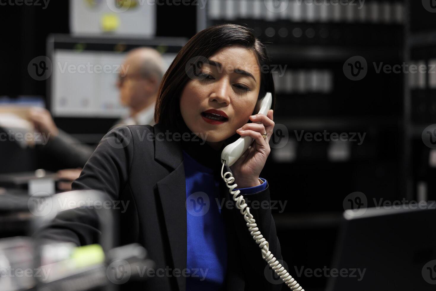 Business accountancy consultant making phone call in professional administrative workplace. Employee in business company file cabinet depository filled with flowcharts and folders photo