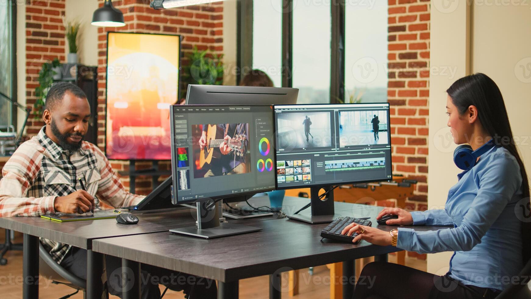 Professional artist working on film footage design with retouching software, using monitors in agency office. Post production house creative editor creating audio and video montage. photo