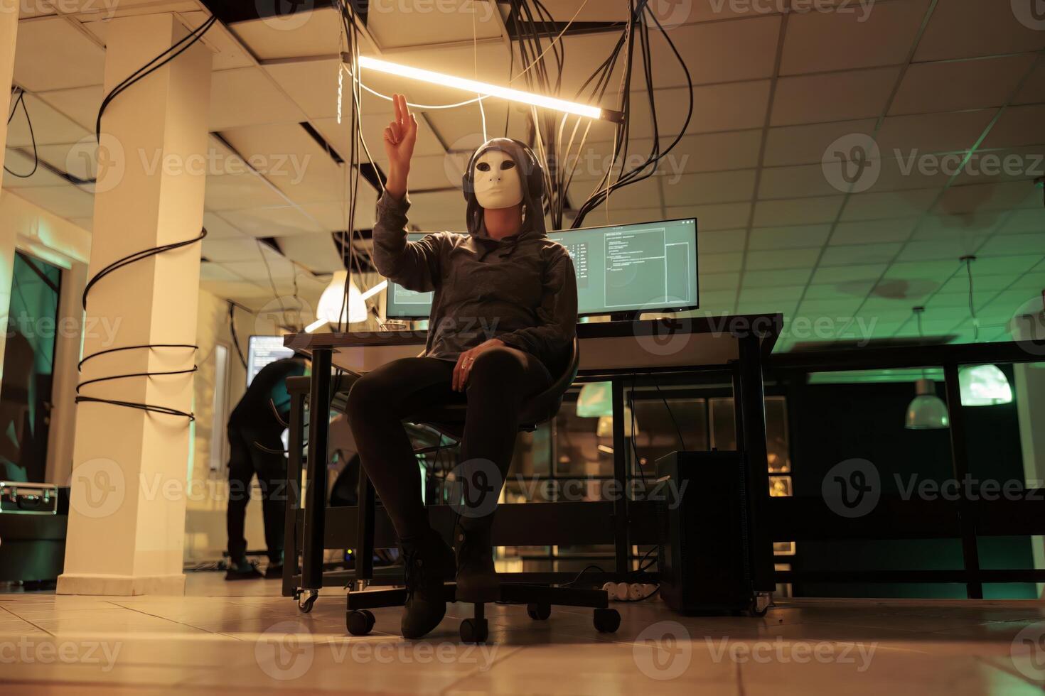 Anonymous hacker making hand gesture in augmented reality, attacking database server, cybercrime. Computer system hacking simulation, information phishing, malware programming in ar photo