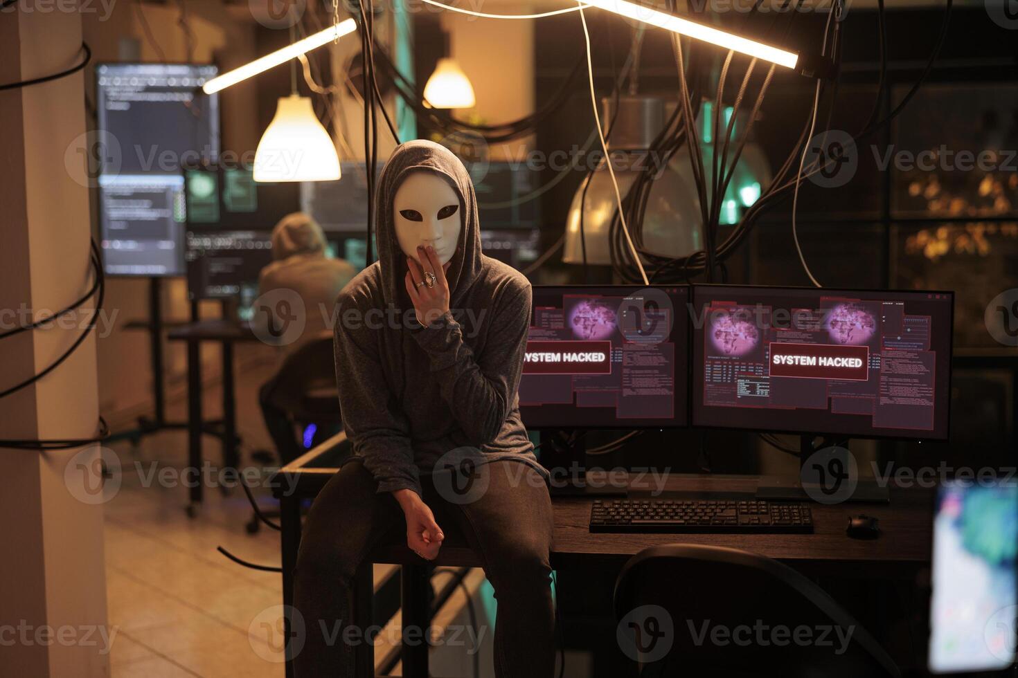 Anonymous hacking computer system, breaking into online server, attacking database. Cybercrime, woman hacker stealing information, programming malware software portrait at night time photo