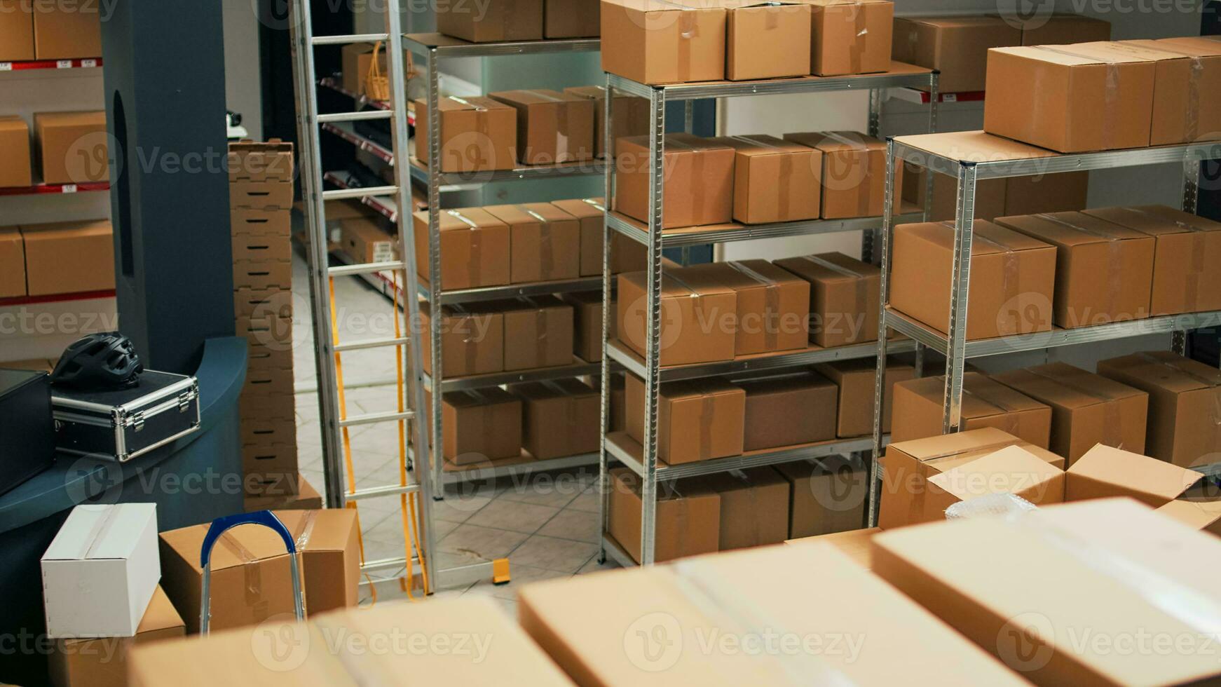 Warehouse filled with raw materials and racks to put cardboard boxes, preparing packages with merchandise and products for shipping. Empty storage room used for quality control, small business. photo