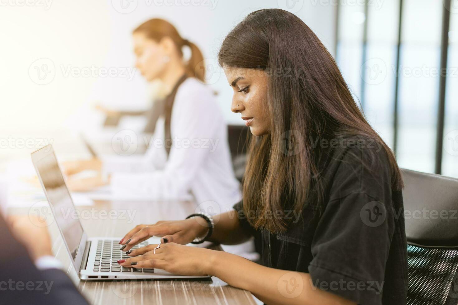 India business woman employee woking in office typing data in laptop