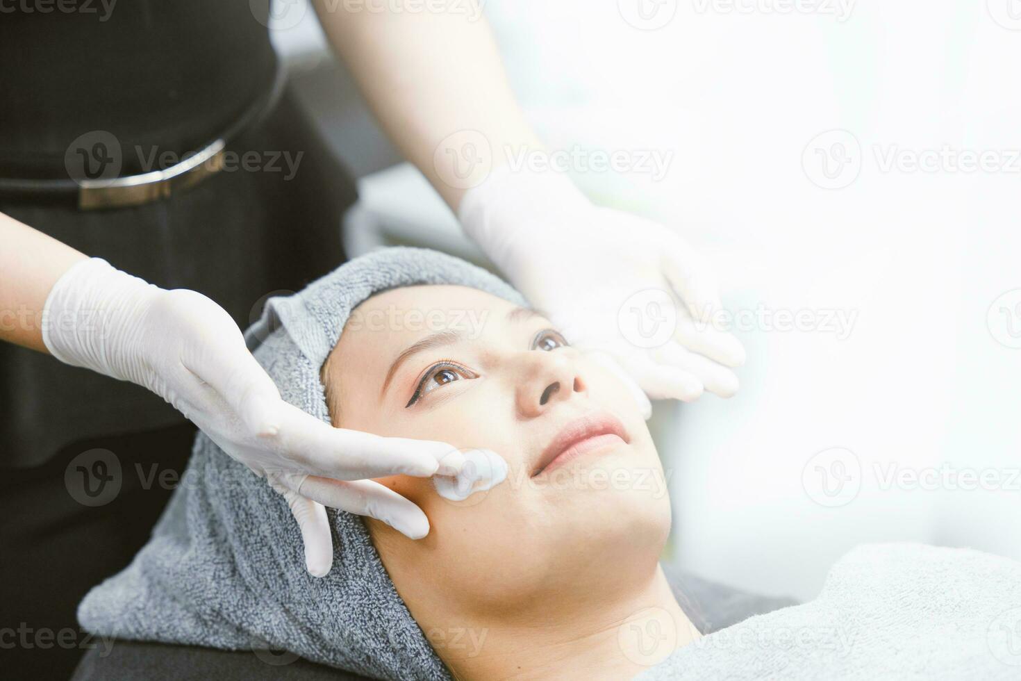 Face massage lady facial skin care cream treatment in spa with white space for advertising text. photo