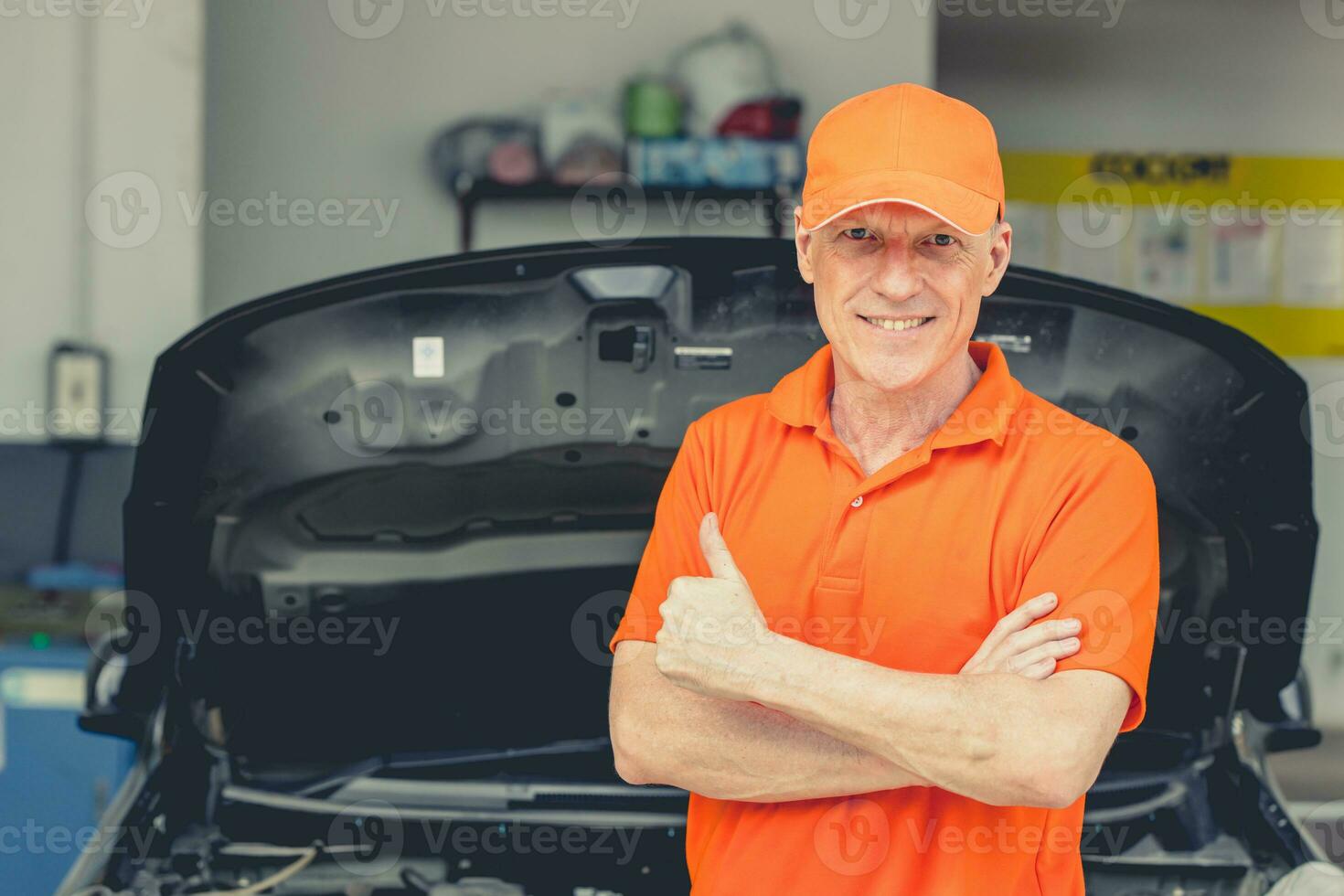 Senior Professional look Car Mechanic Standing in Garage. Portrait Happy Smiling Caucasian Adult Male in Auto Service Thumbs up. photo