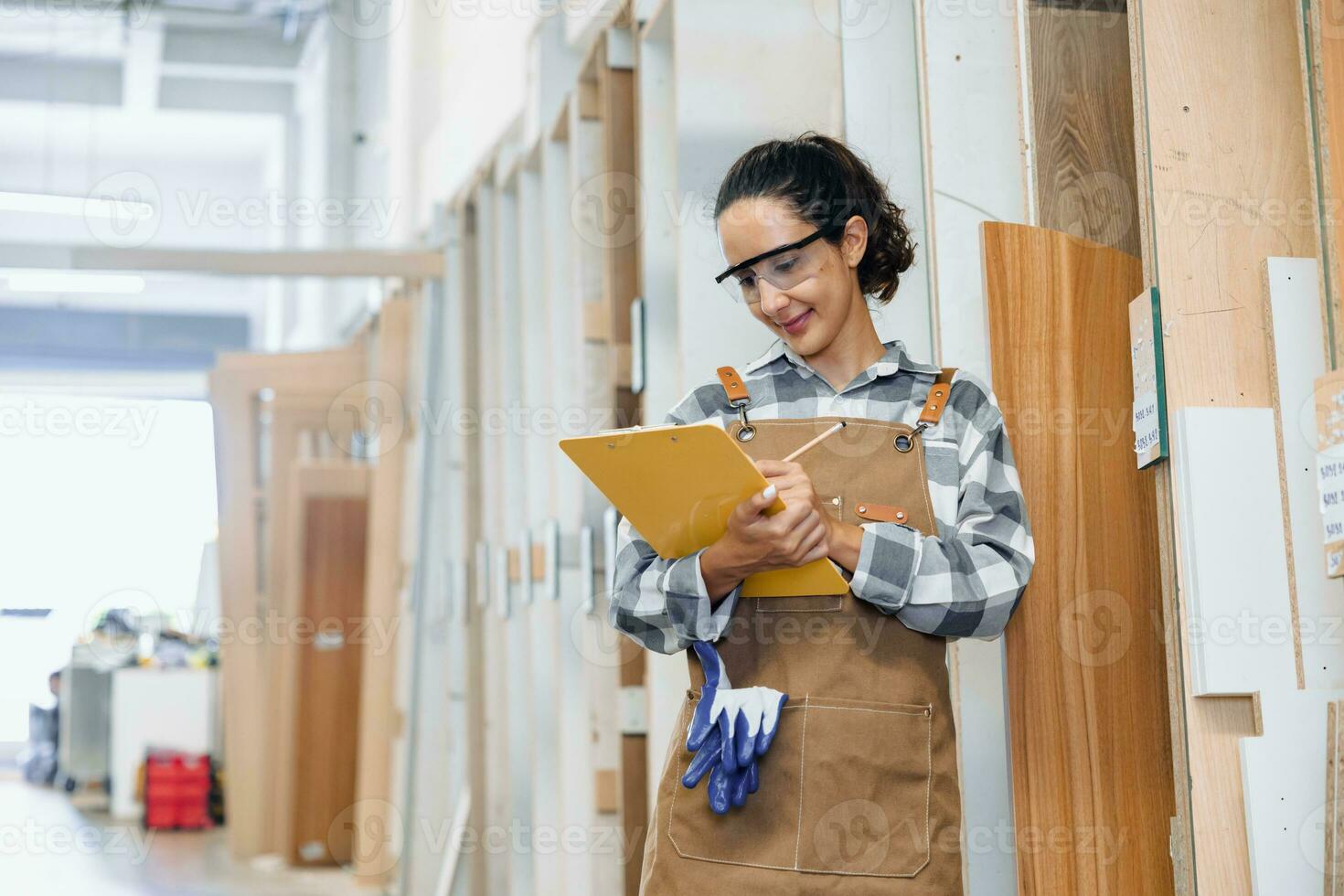 staff working in wood furniture industry factory checking inventory of plywood wooden board type material in stock wood store warehouse. photo