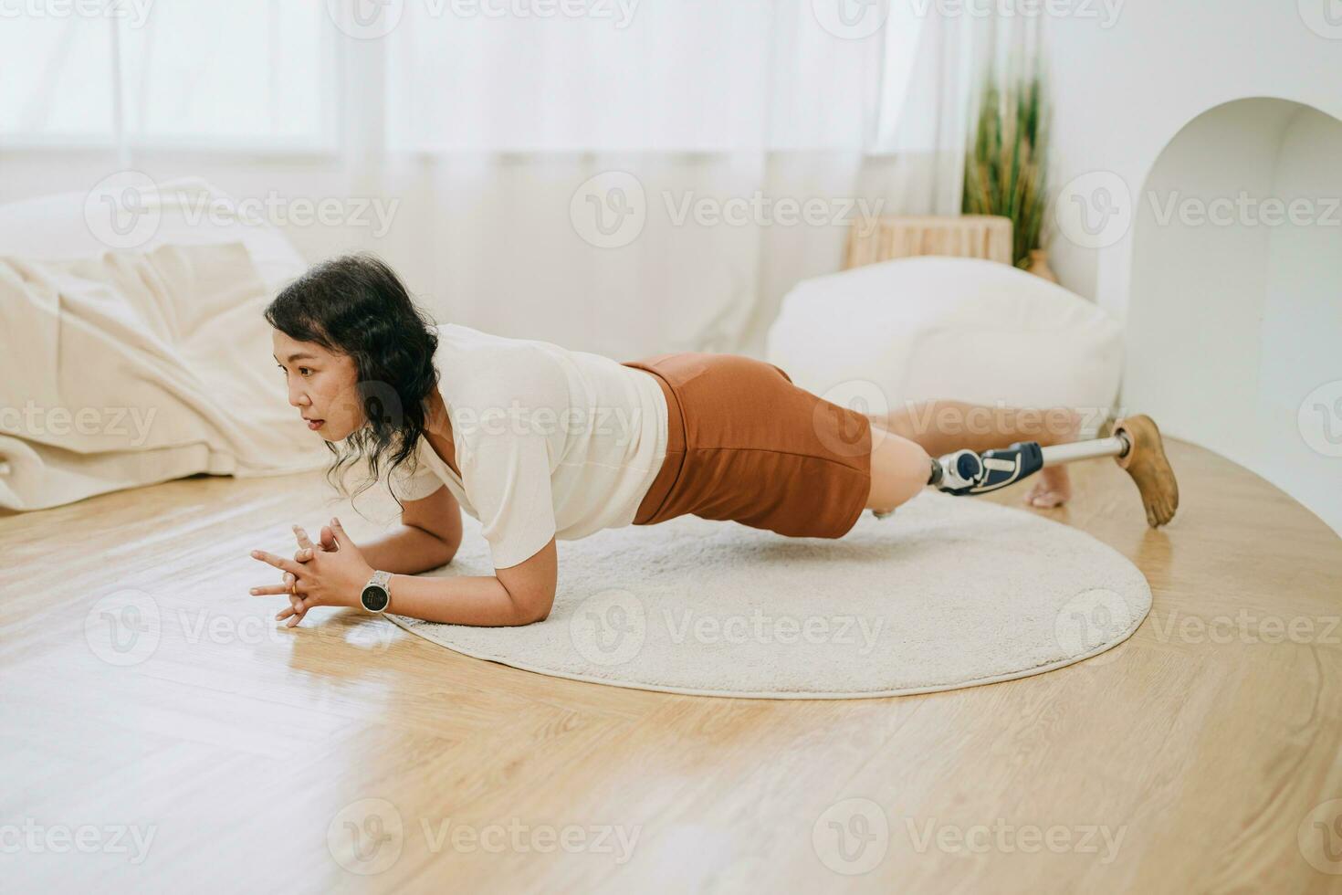 prosthetic leg people training planks exercise at home. disability asian woman healthcare activity indoor. photo