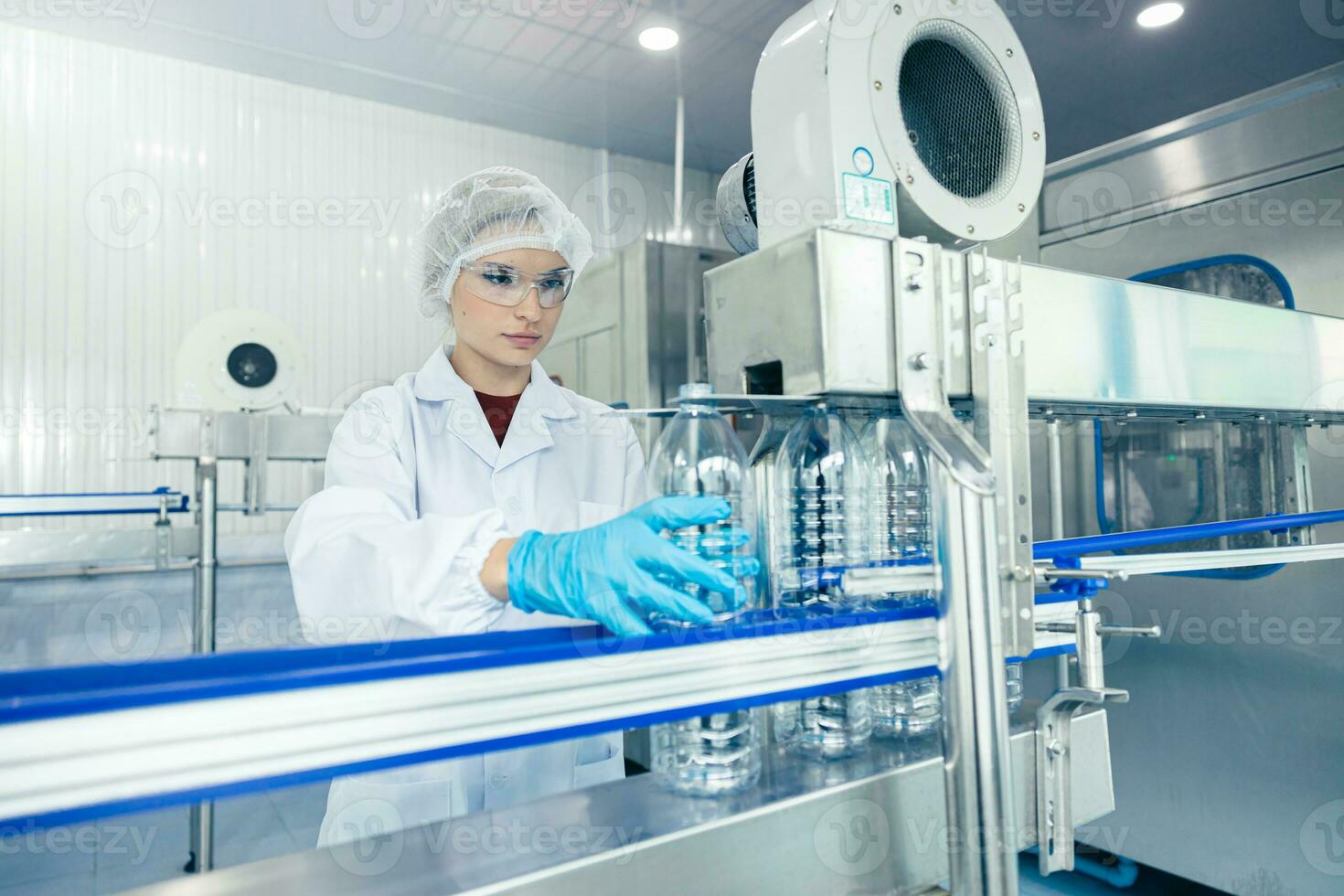 worker in drinking water factory. women workers caucasian labor in beverage clean production conveyor belt mineral water manufactory. photo