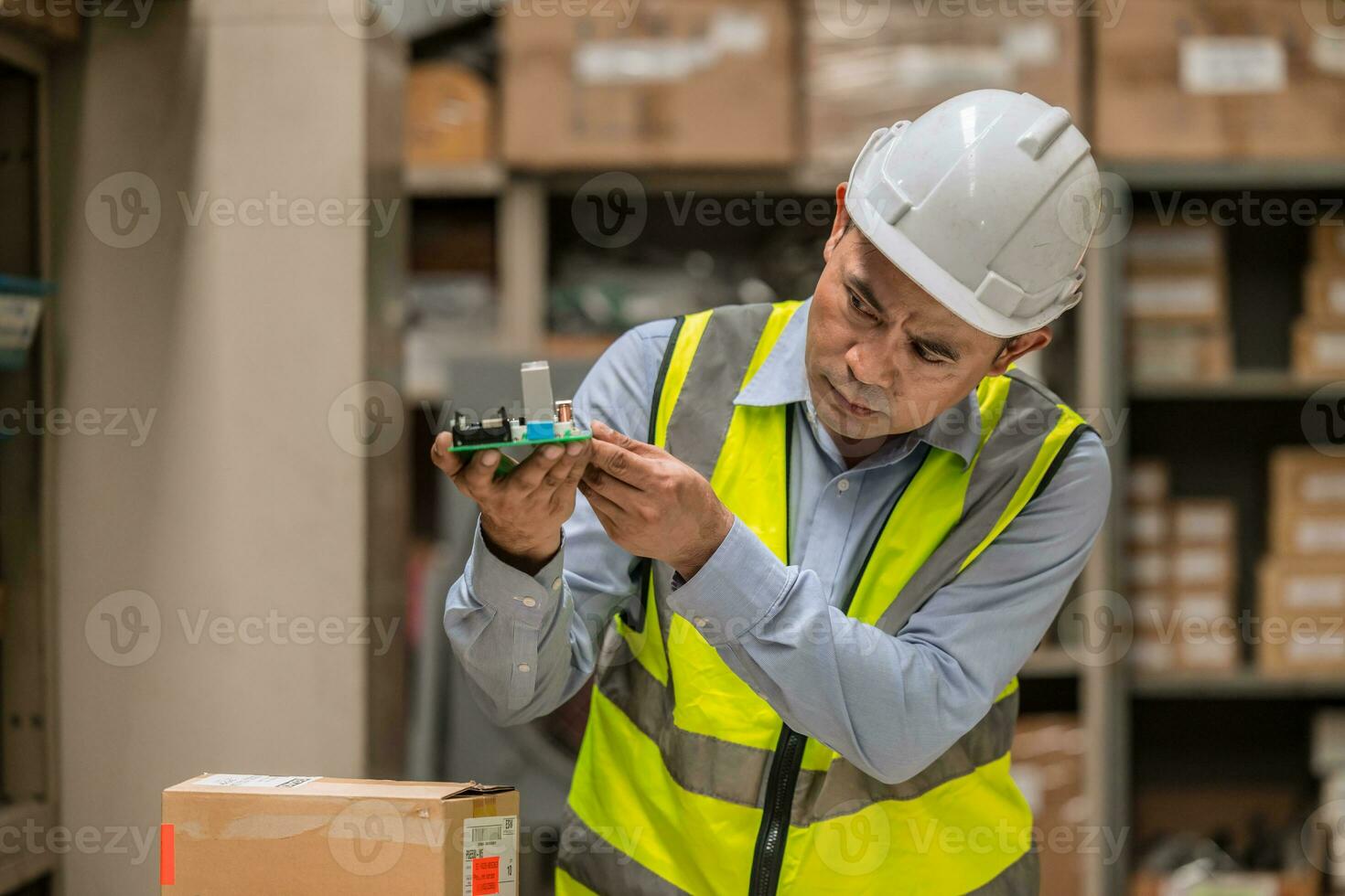 senior mananger products inspector quality control checking examination hardware electornics part before shipping or receiving in inventory store collection photo