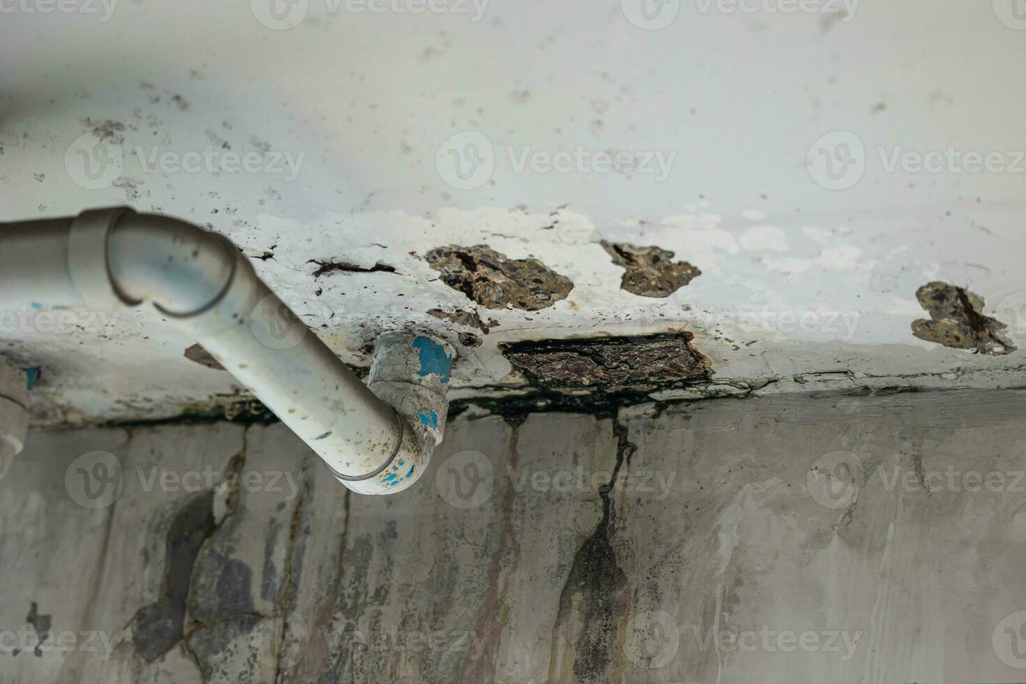 sewer pipe leak bad old plumbing water leakage inside the concrete wall rusty damaged building structure photo