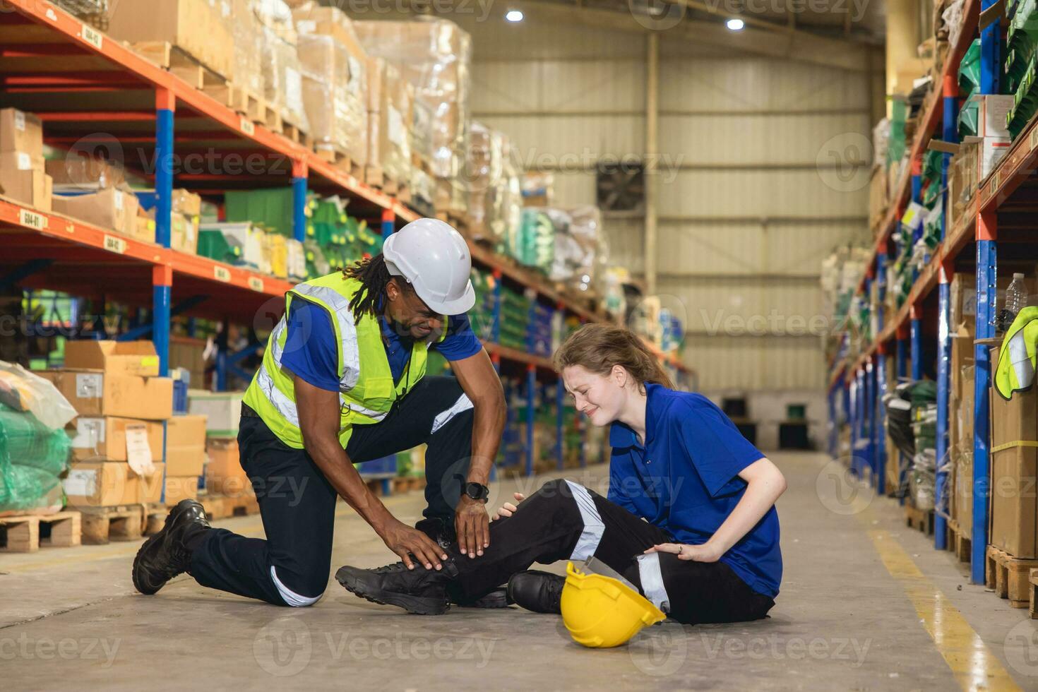 young woman warehouse worker accident leg injury slip and fall ankle sprain friend help support photo