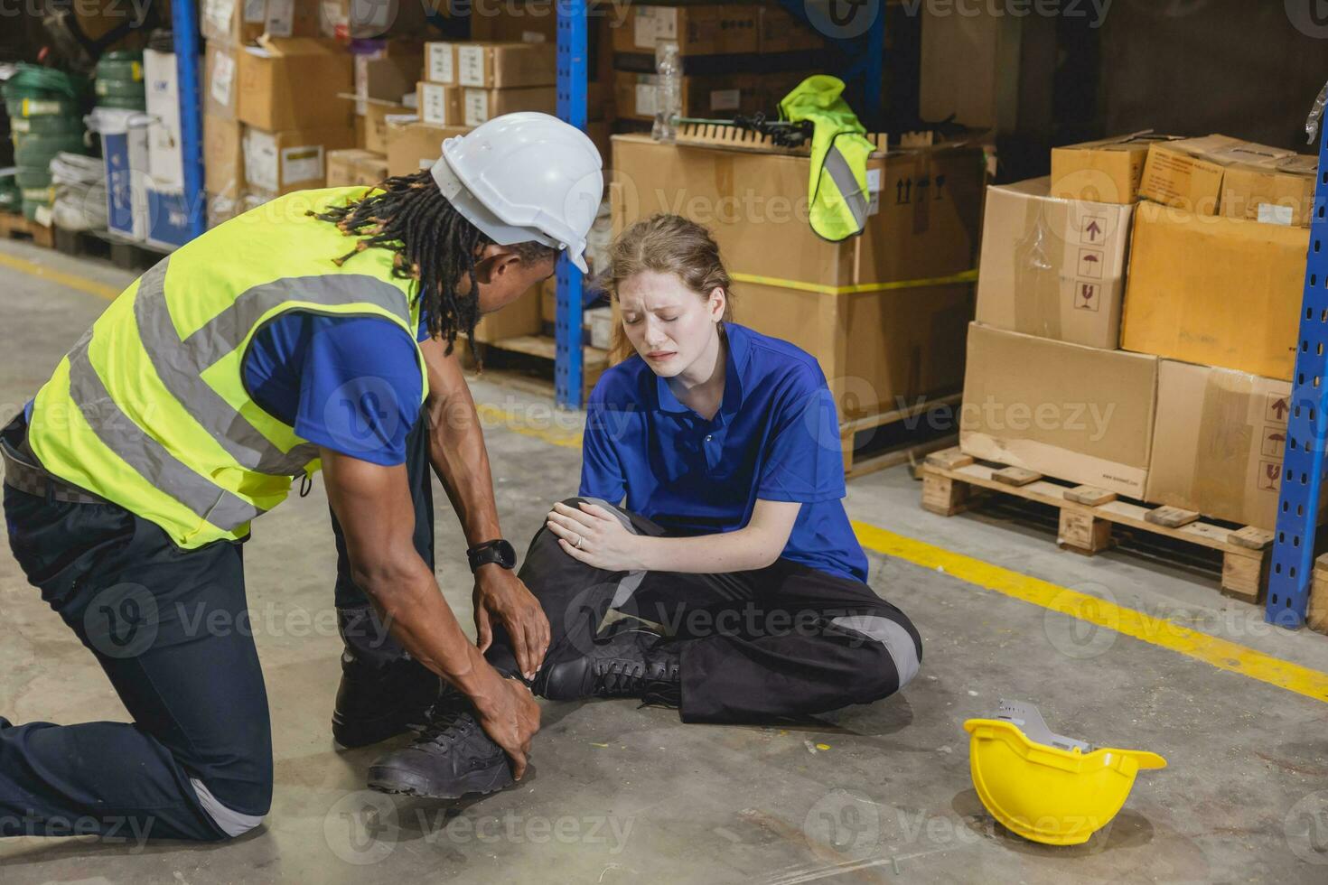 young woman warehouse worker accident leg injury slip and fall ankle sprain friend help support photo