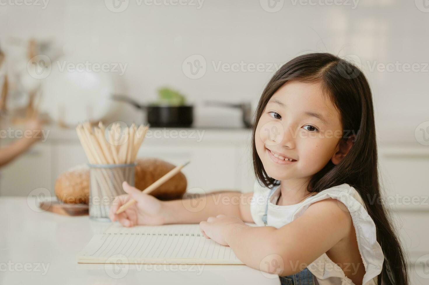 Cute child girl happy learning education doing home work at home holiday photo
