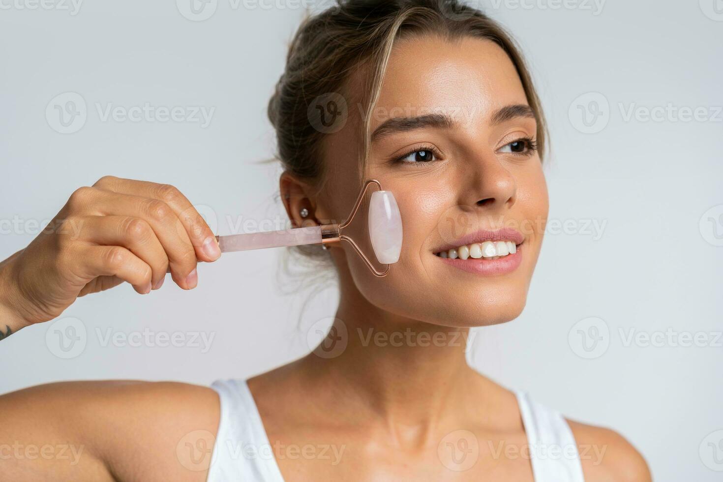 Face massage. Portrait of  beautiful  female fashion model isolated on  white studio background. Blond caucasian woman with healthy well-kept skin. Style and beauty, skin care concept. photo