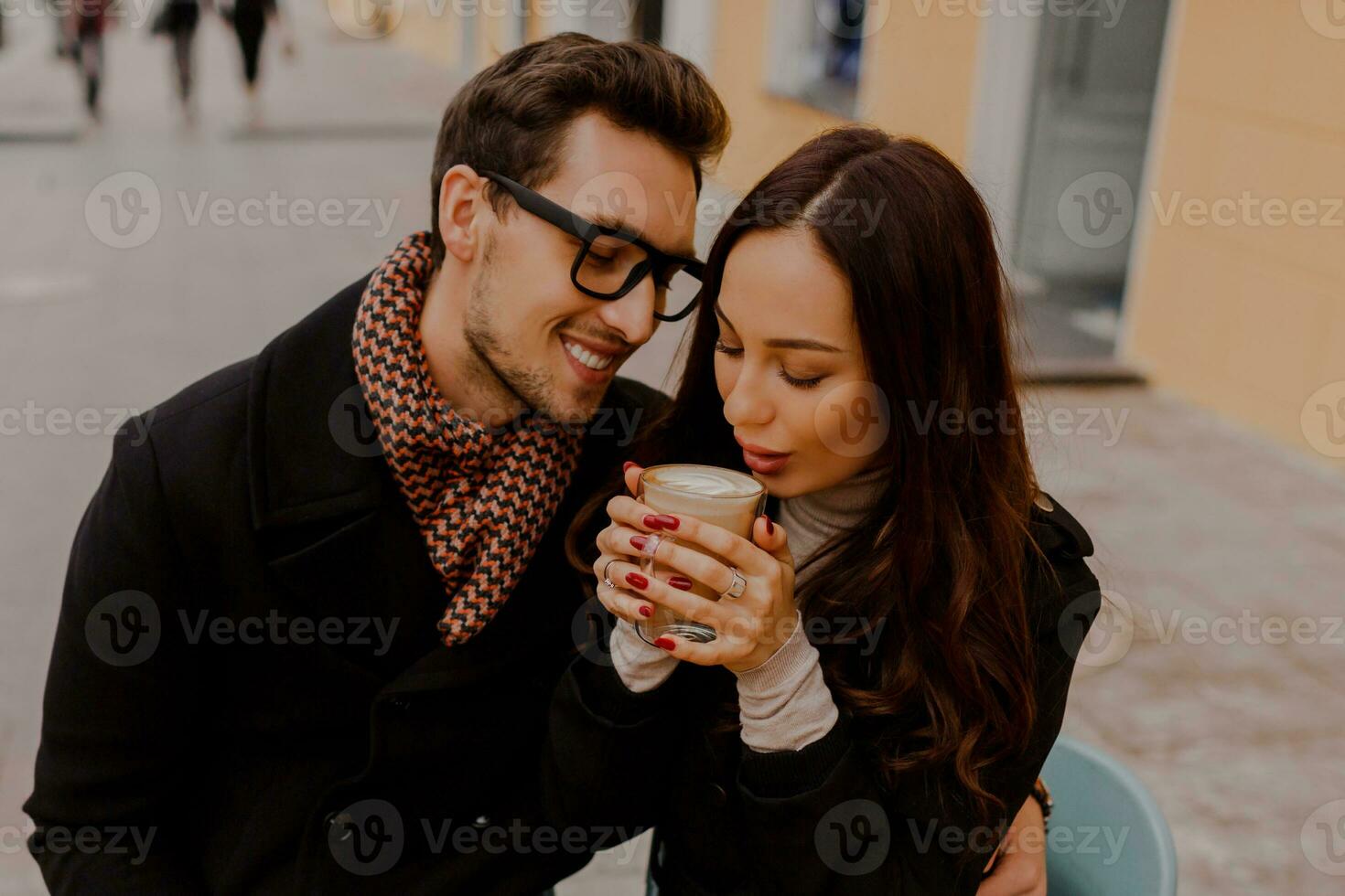 Romantic couple dating in cozy cafe on the street. Autumn mood. photo