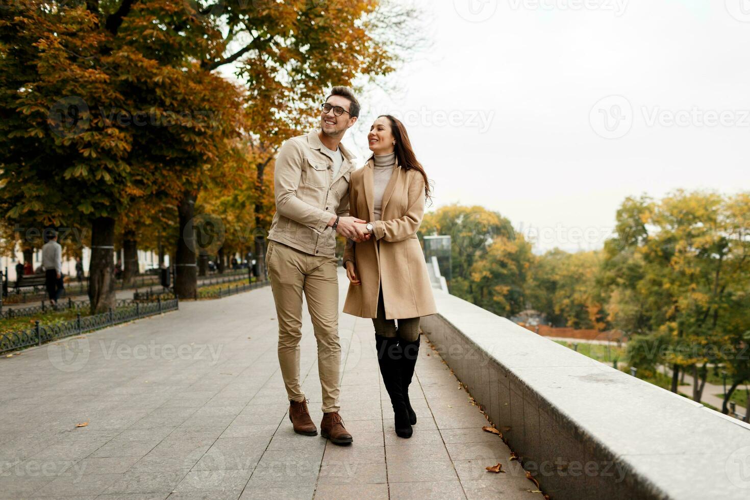 Outdoor  photo of happy young woman with her boyfriend enjoying date. Cold season.