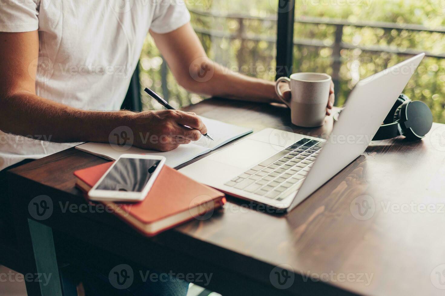 Handsome hipster man with beard using lap top at home photo