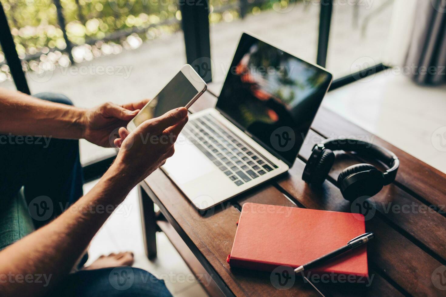 Handsome hipster man with beard using lap top at home photo
