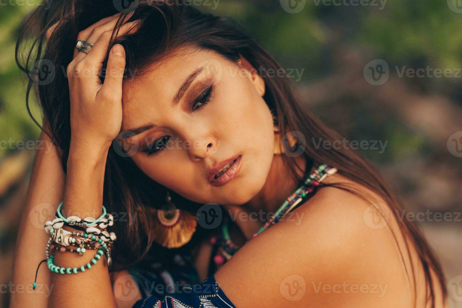 Close up portrait of beautiful asian woman in tropical outfit posing on the beach. photo