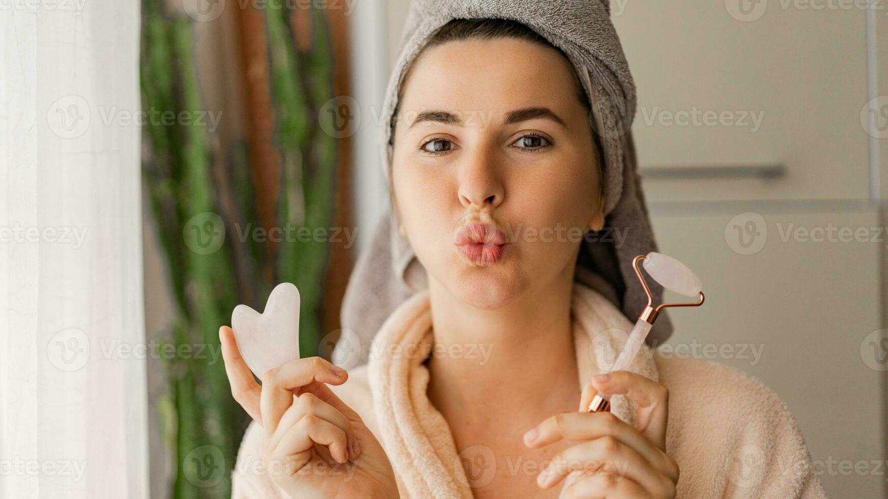 Beautiful young woman with natural make up shows gel, cream or mask sample on her face. SPA, wellness, bodycare and skincare. Close up, selective focus. photo