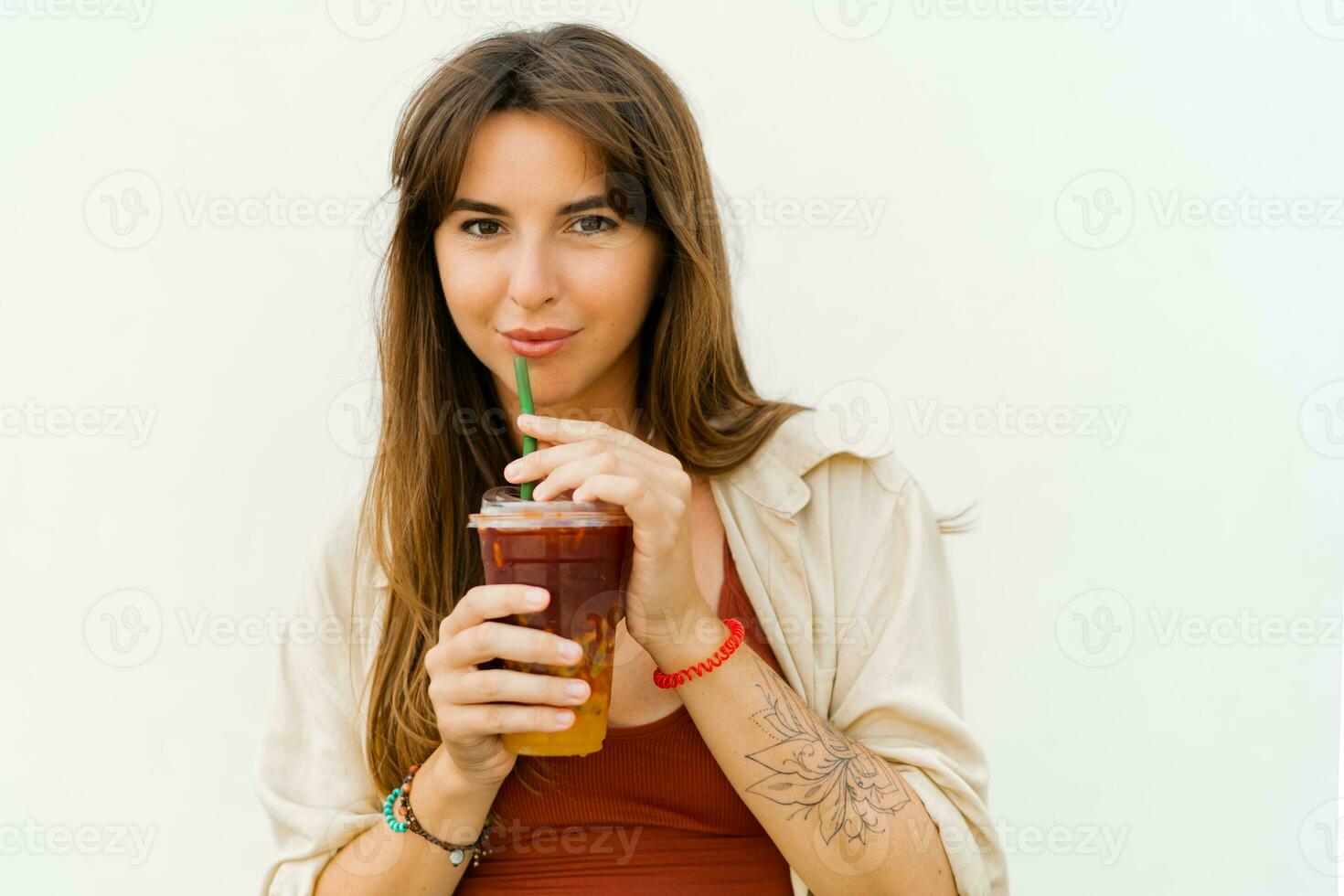 Close up portrait of Smiling european woman  in stylish summer outfit drinking   sweet lemonade  on white background. photo