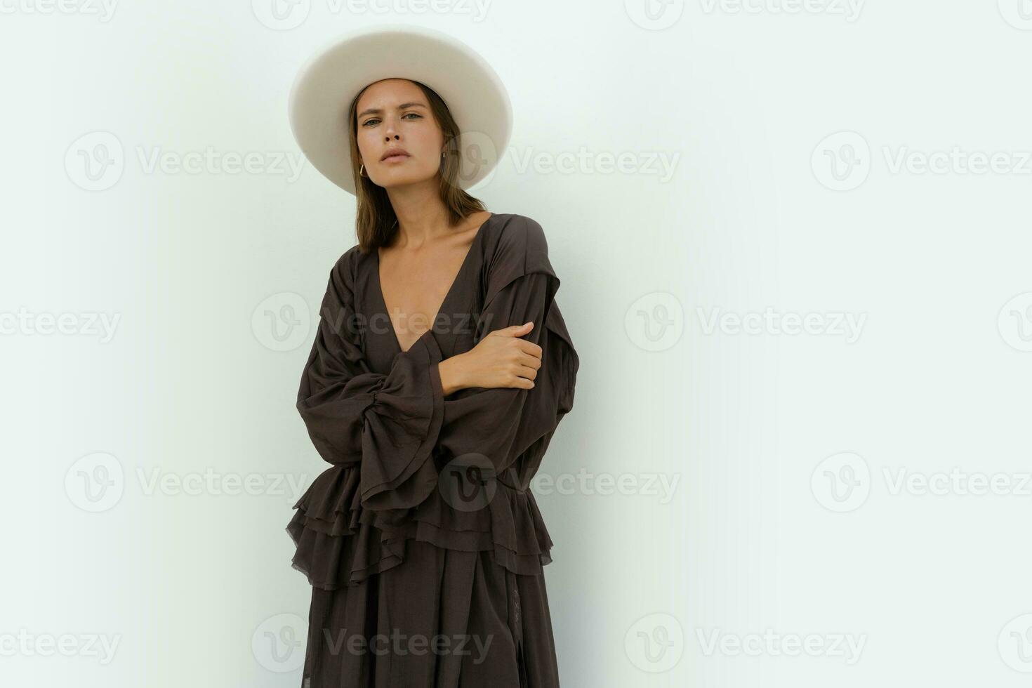 Fashion model in stylish  white field proper hat and trendy casual dress posing in studio on white background. photo