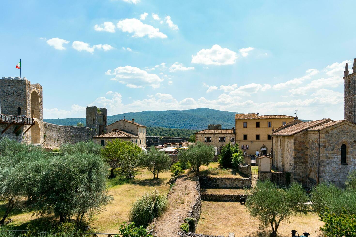 Monteriggioni,Italy-august 10, 2020-View of medieval village of Monteriggioni from above the walls during a sunny day photo