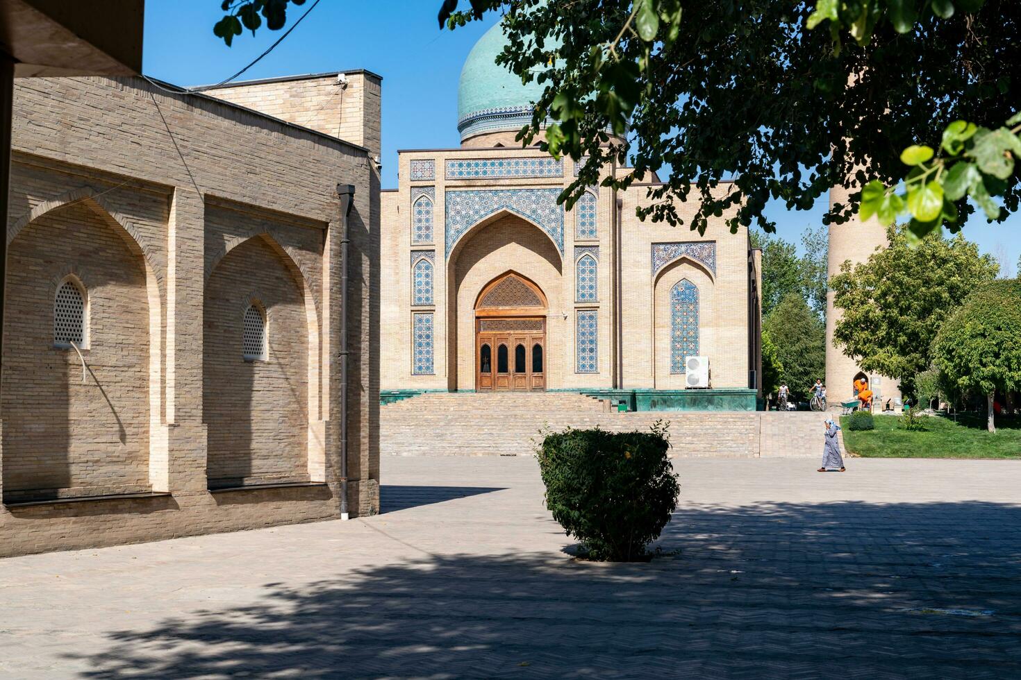Tashkent, Uzbekistan-august 11, 2023-people visit the Hazrati Imam complex during a sunny day.The complex is a square that includes a set of religious buildings in Tashkent photo