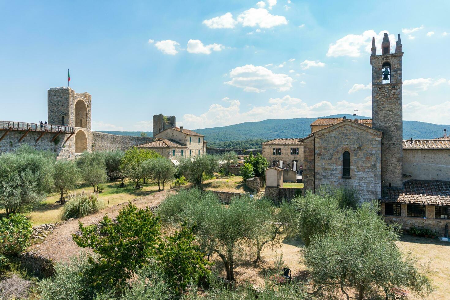 Monteriggioni,Italy-august 10, 2020-View of medieval village of Monteriggioni from above the walls during a sunny day photo