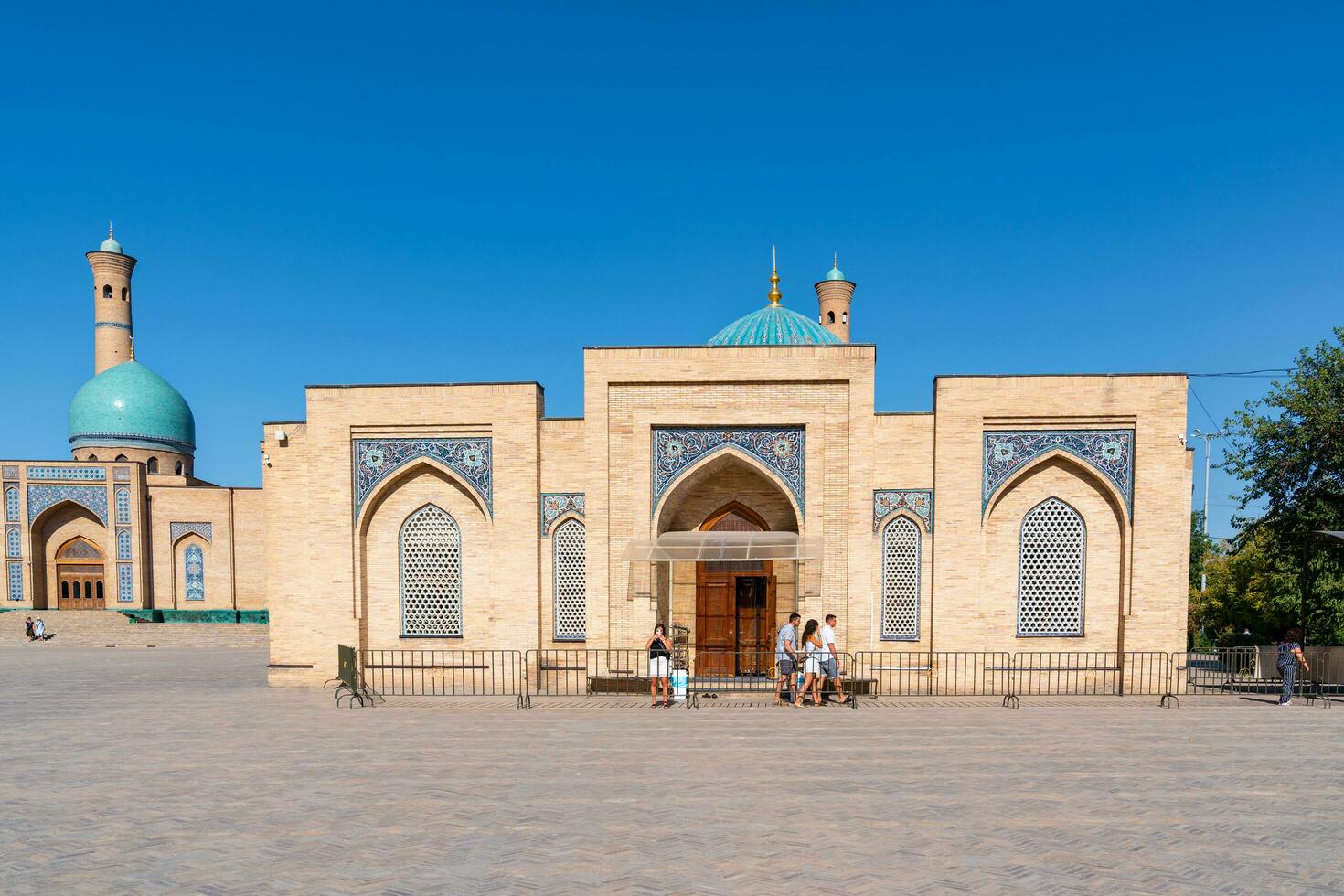 Tashkent, Uzbekistan-august 11, 2023-people visit the Hazrati Imam complex during a sunny day.The complex is a square that includes a set of religious buildings in Tashkent photo