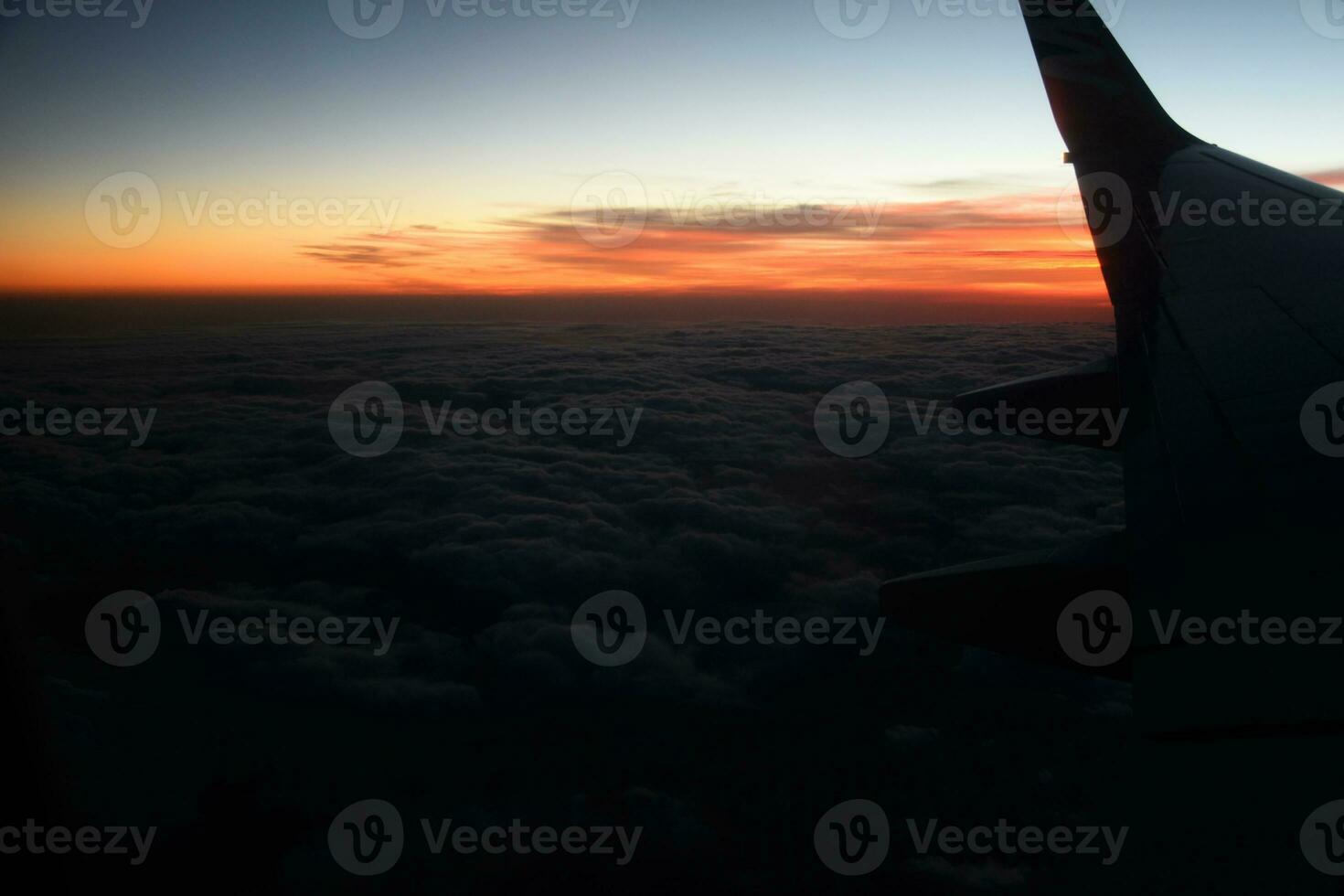 mysterious sunset with clouds from the airplane window with photo