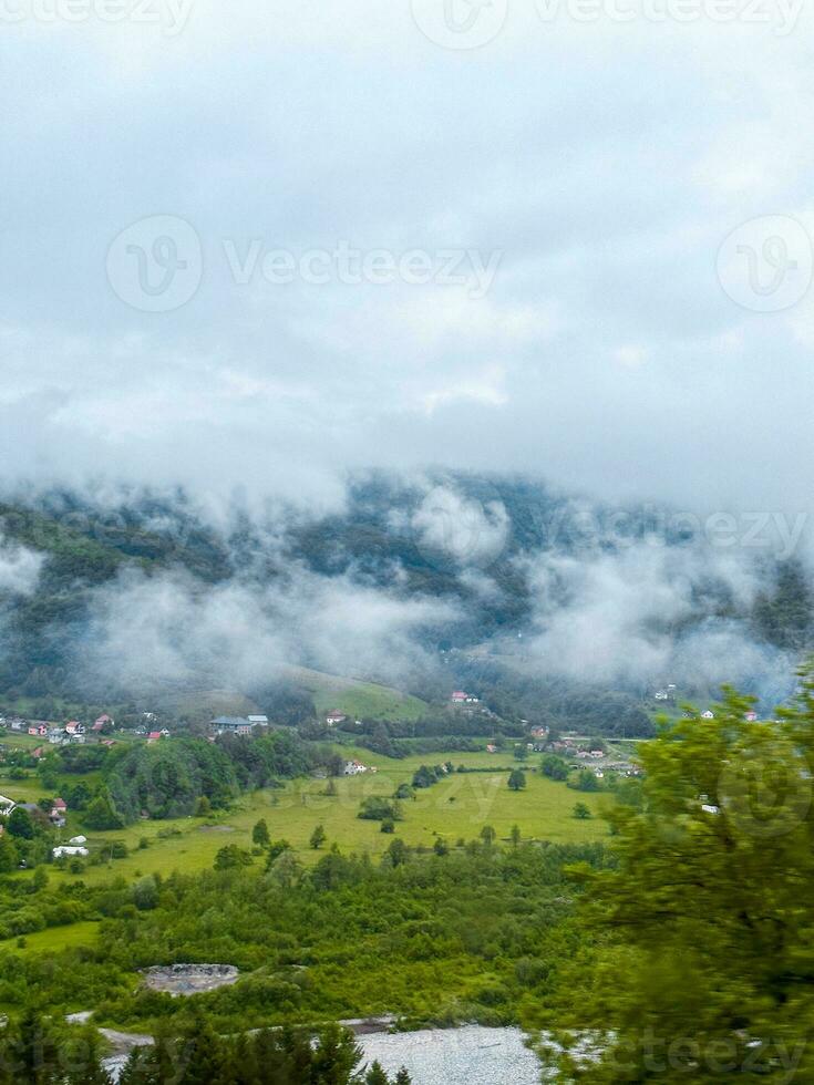 view of a summer day in the mountains, green meadows, mountain slopes and hills photo