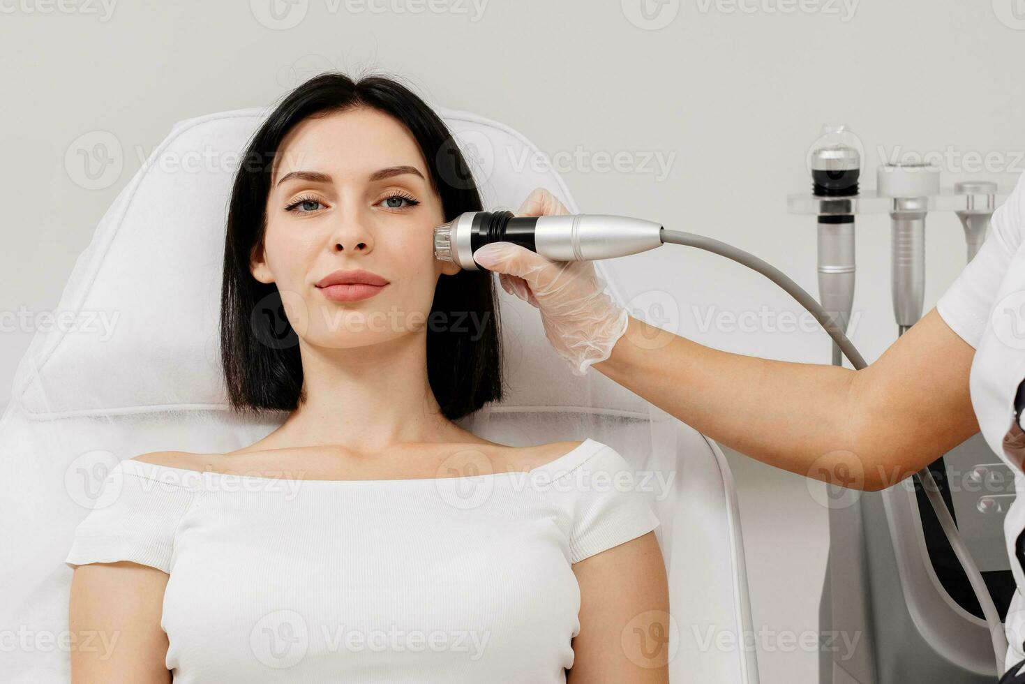 Micro-Needle RF Lifting Neck Skin. Caucasian female getting RF lifting procedure of face and neck area at cosmetology clinic. Professional skincare, beauty treatment photo