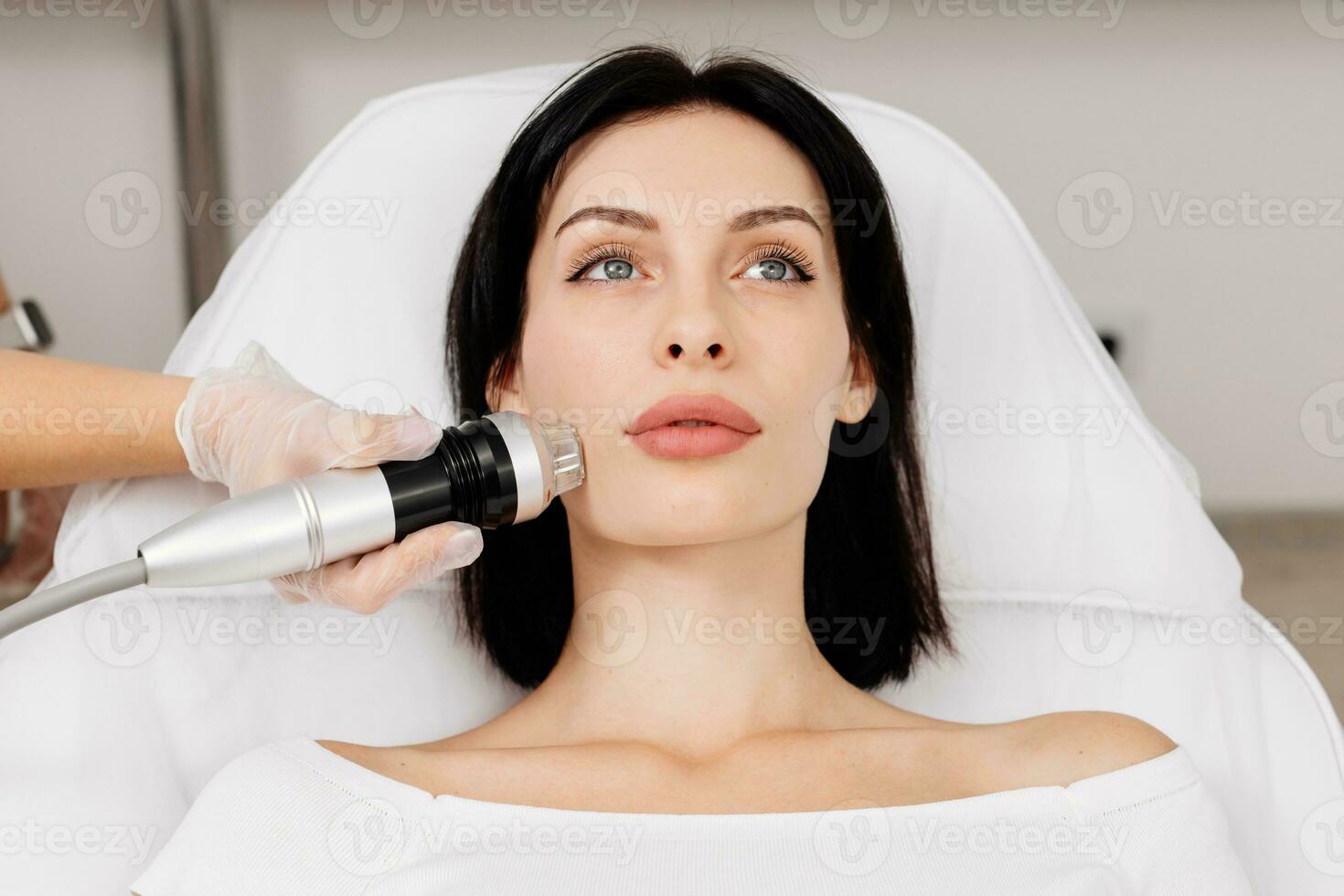 Micro-Needle RF Lifting Neck Skin. Caucasian female getting RF lifting procedure of face and neck area at cosmetology clinic. Professional skincare, beauty treatment photo