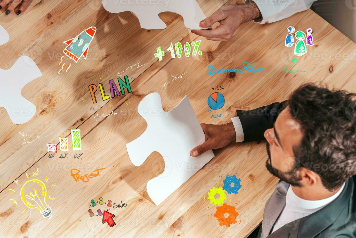 Businessmen working together to build a puzzle as teamwork, partnership and integration concept photo