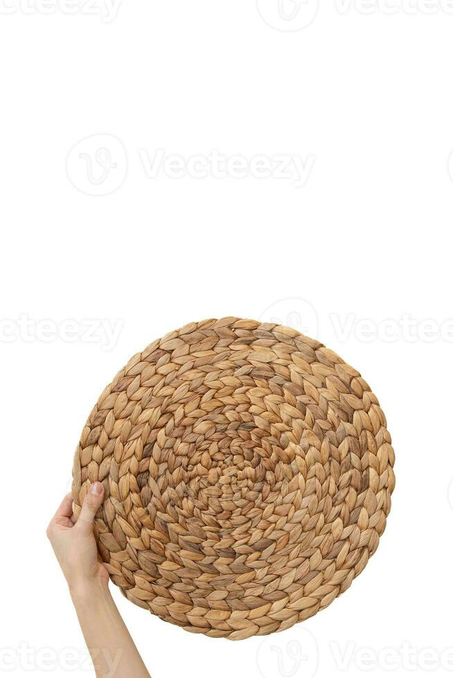 Hand holding Straw table mats on the white isolate background. photo