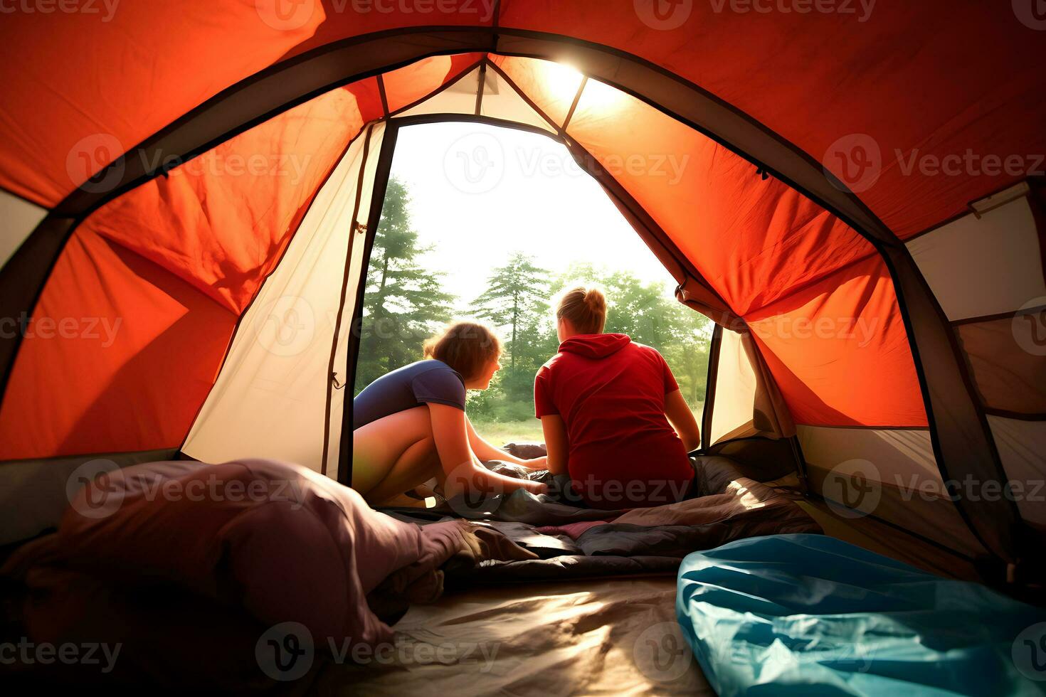 Two women sit near a tourist tent and enjoy the view of nature in sunny weather. View from the back, inside the tent. AI Generative photo