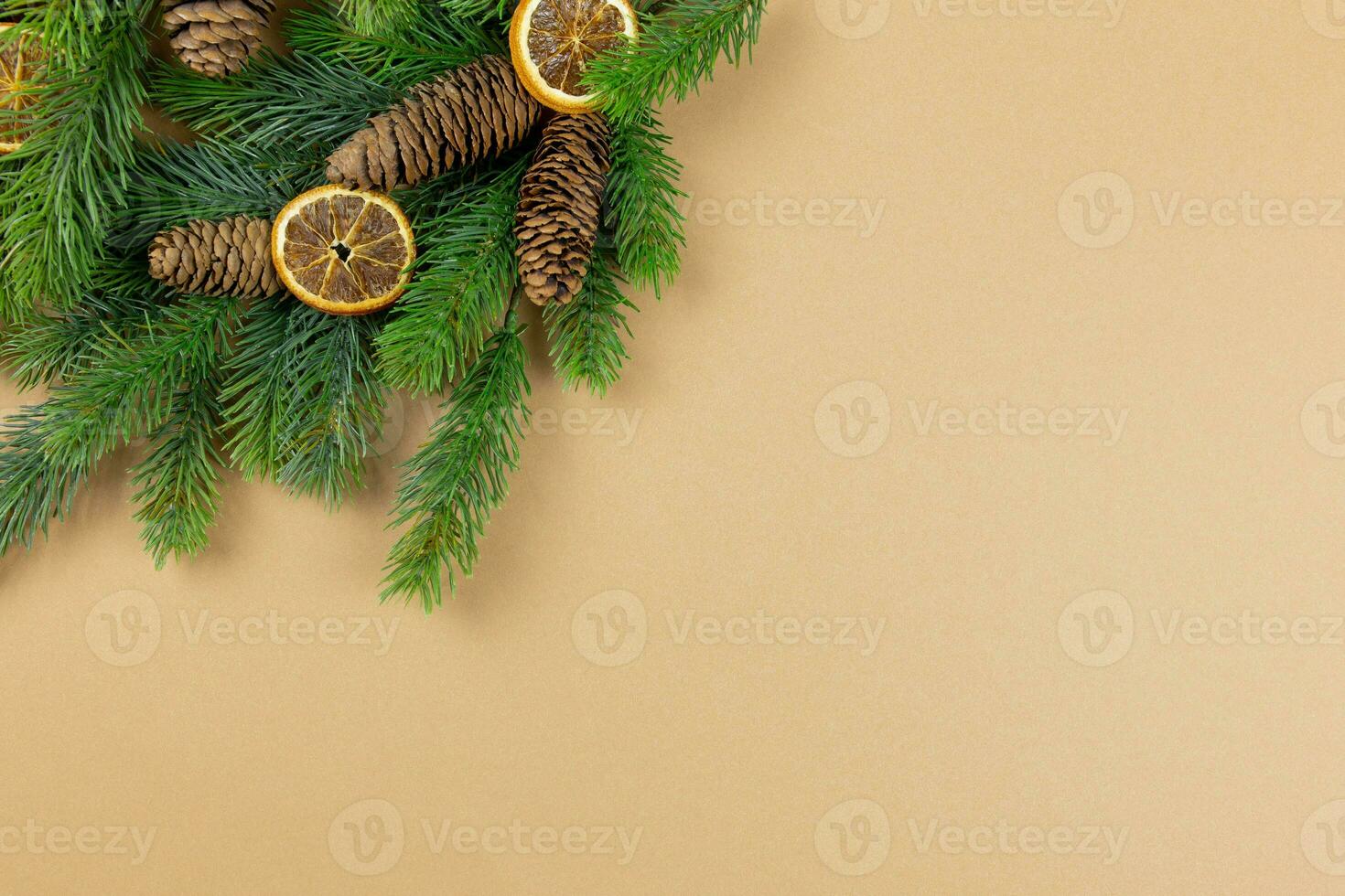 Christmas flat lay background with fir tree branches, pine cones and christmas decorations on craft paper background. Top view. Copy space. photo
