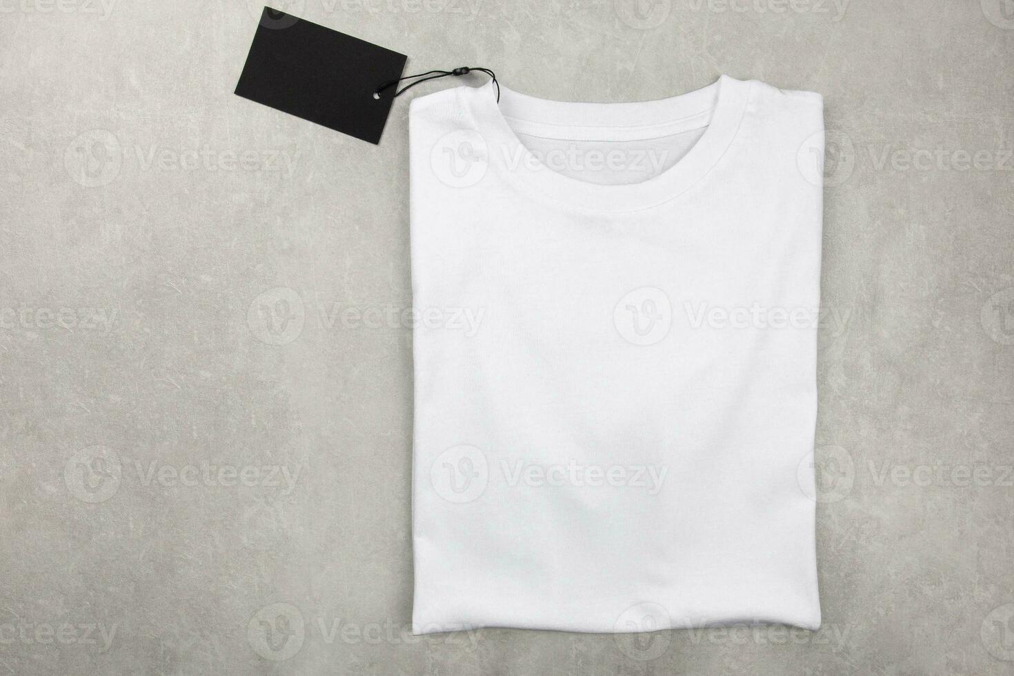 White womens cotton Tshirt mockup with label. Design t shirt template, print presentation mock up. Top view flat lay. Concrete stone background. photo