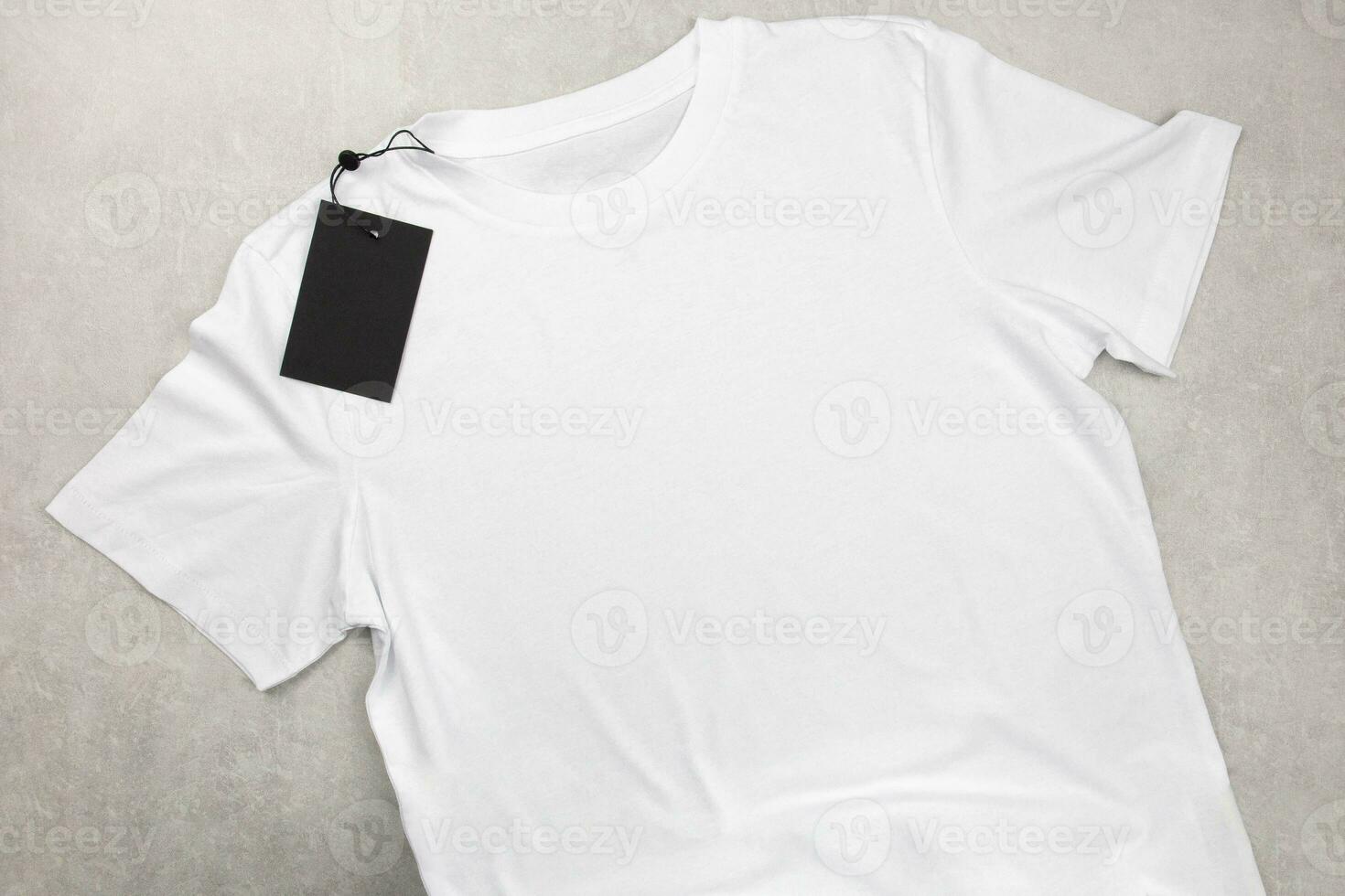 White womens cotton Tshirt mockup with label. Design t shirt template, print presentation mock up. Top view flat lay. Concrete stone background. photo