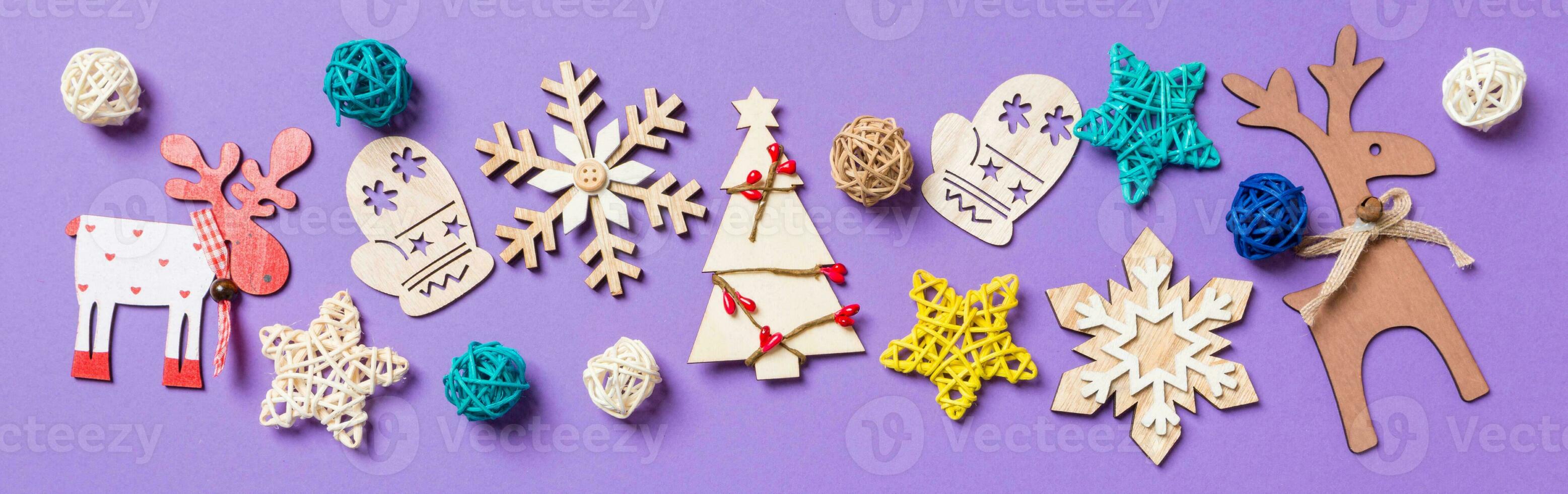 Festive decorations and toys on purple background. Merry Christmas Banner concept with copy space photo