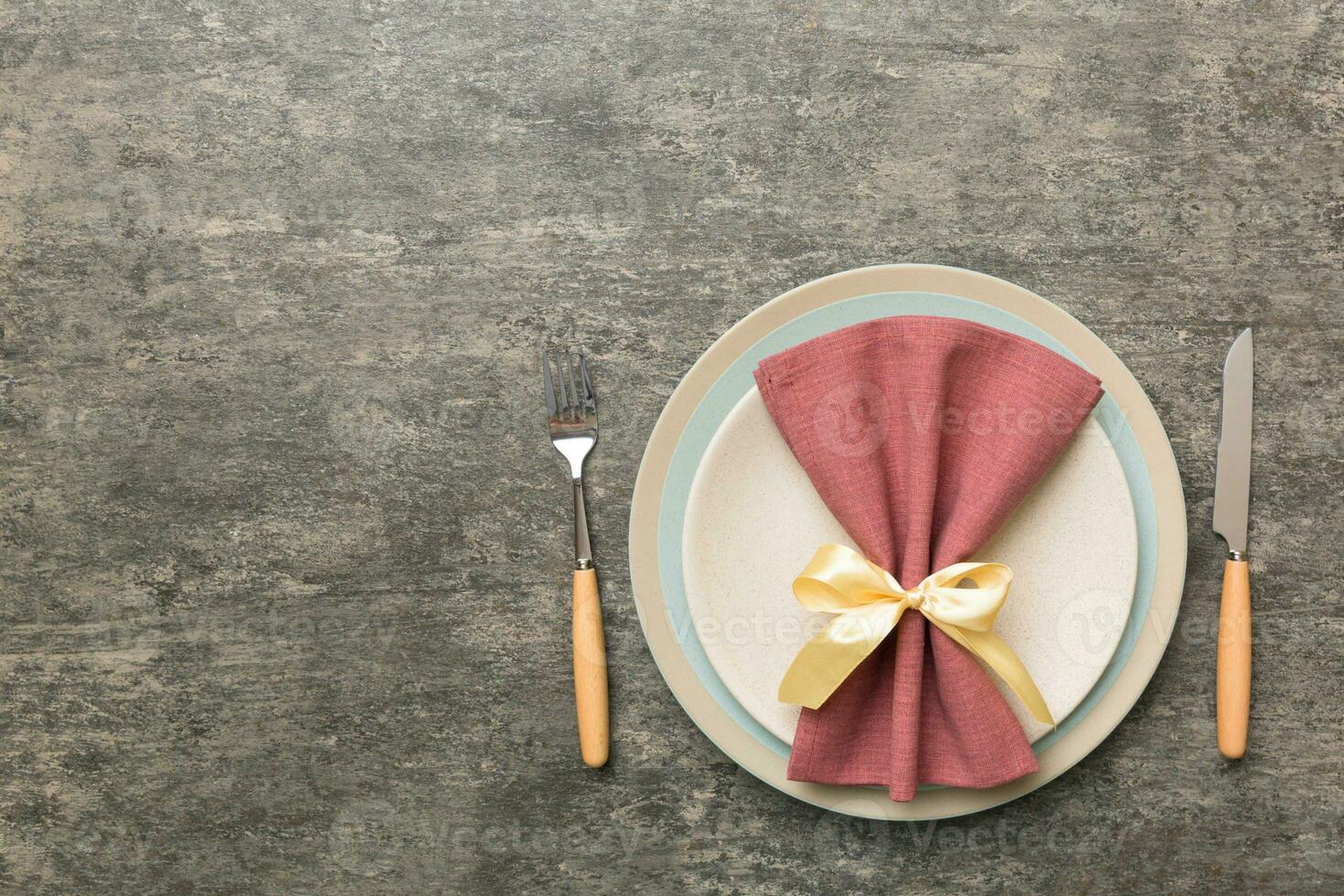 Christmas table place setting with christmas decor and plates, kine, fork and spoon. Christmas holiday background. Top view with copy space photo