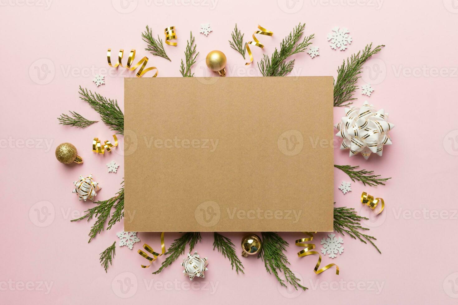 Flat lay Christmas composition. square Paper blank, pine tree branches, christmas decorations on Colored background. Top view, copy space for text photo