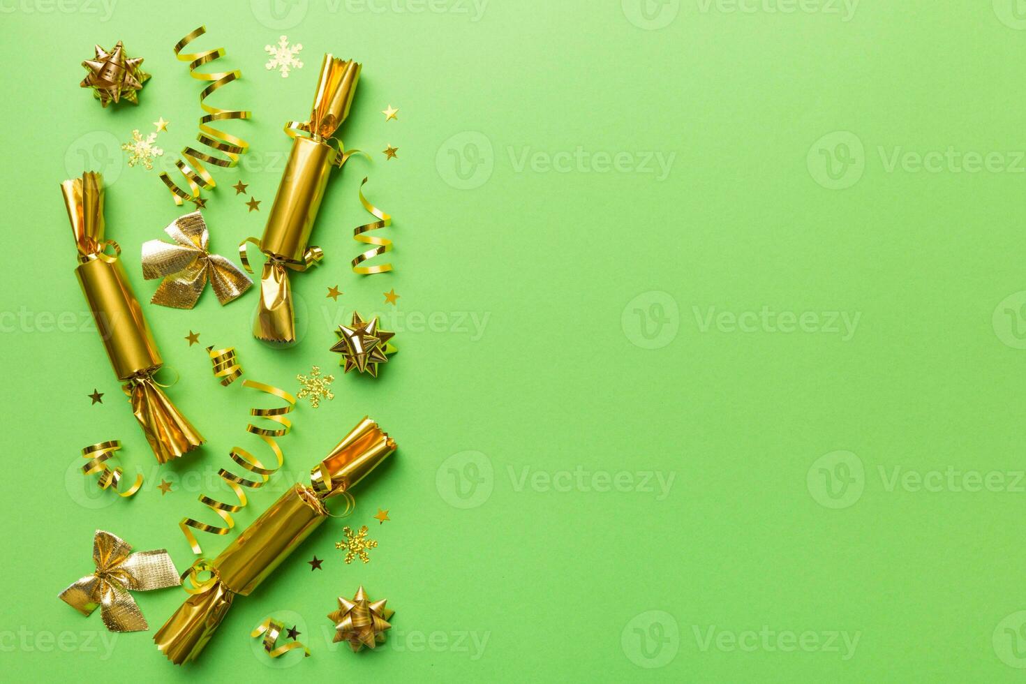 Christmas crackers with shiny confetti on color background, top view, copy space photo