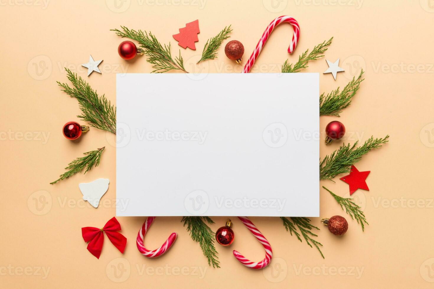 Flat lay Christmas composition. square Paper blank, pine tree branches, christmas decorations on Colored background. Top view, copy space for text photo